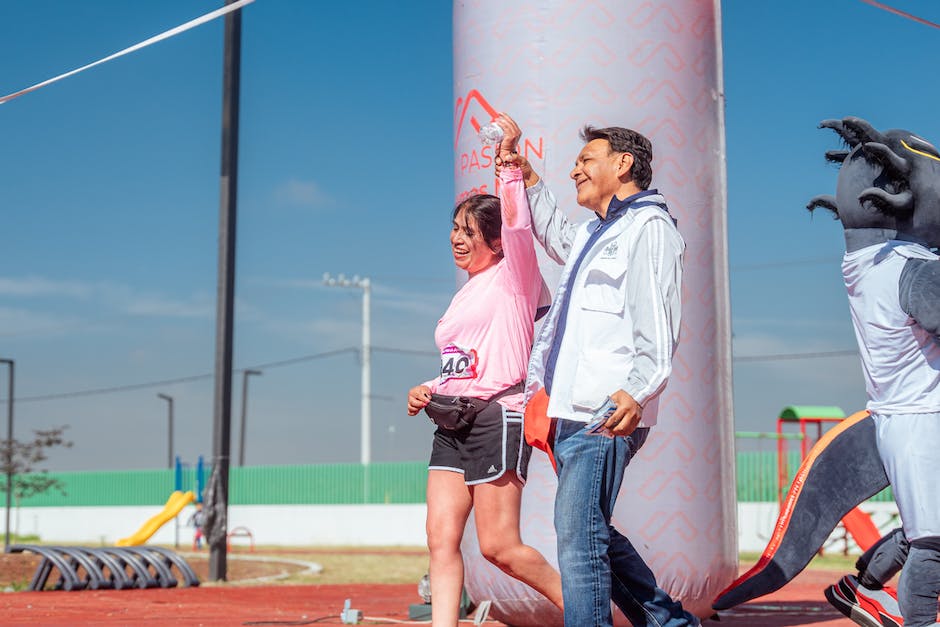 A person crossing the finishing line, symbolizing achieving self-discipline goals.