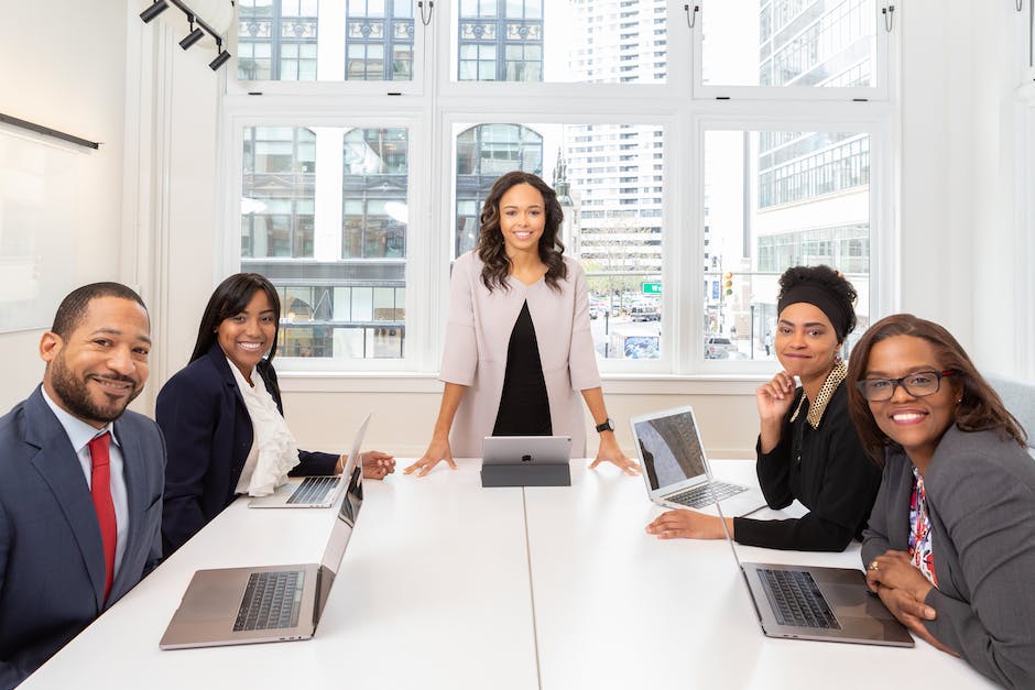 Image depicting employees discussing performance evaluations in a meeting room.